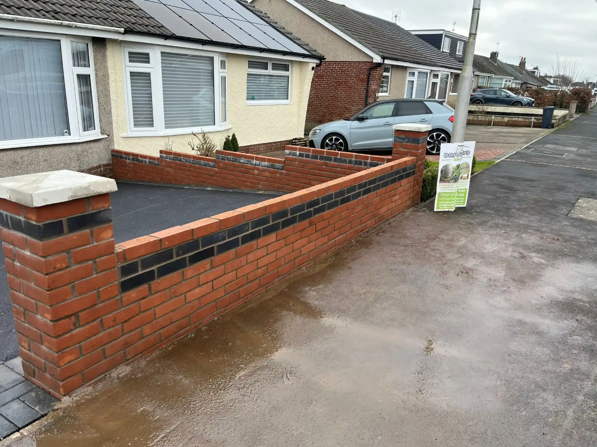 Brick border wall edging a new driveway
